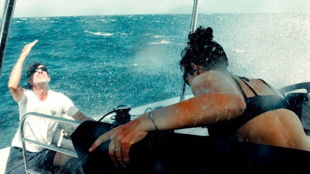 Saskia and Ross bracing themselves onboard. Spray is flying about.