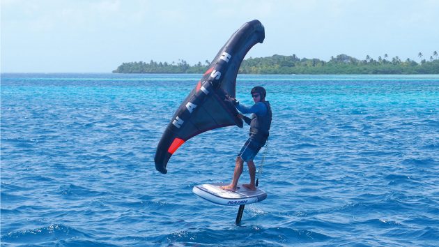 Someone windsurfing with an island behind