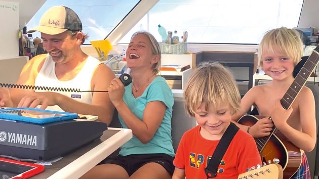 The Bubb family singing and playing in the cockpit on their catamaran adventure